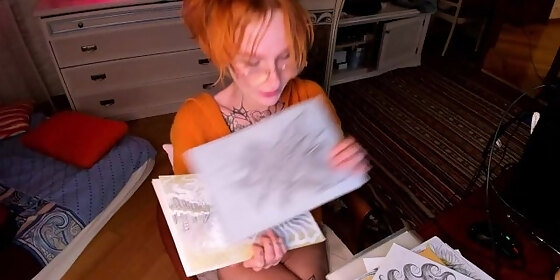 schoolgirl showing her sketch to adult