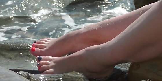 mistress legs barefoot on the summer sea beach
